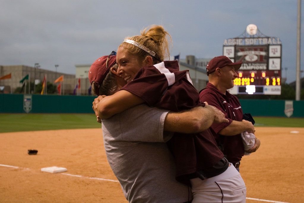 D-backs third base coach watching his daughter at the WCWS